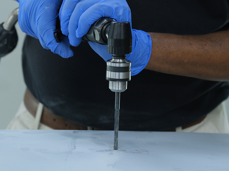 Close up of Hsutech minimal angle low speed drill in use drilling application