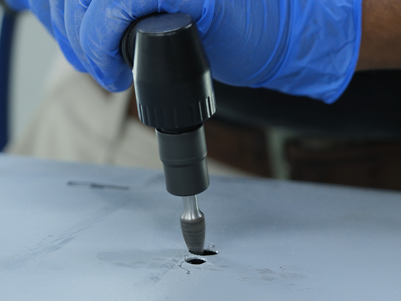 Close up of Hsutech angle die grinder head in use grinding metal surface