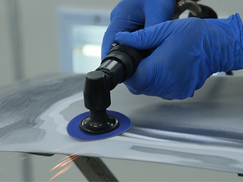 Close up of Hsutech angle sander head in use sanding surface