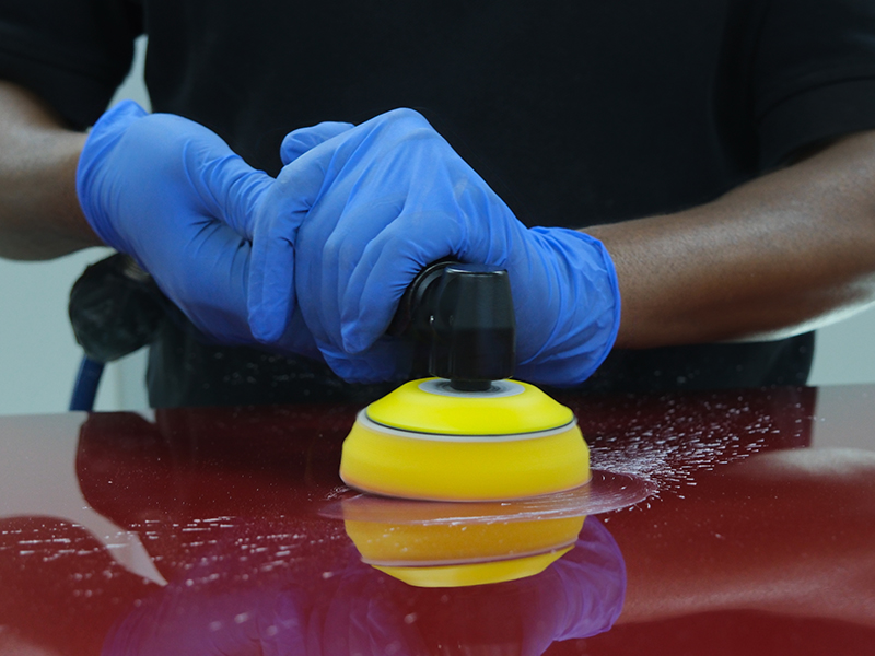 Close up of Hsutech angle polisher head in use polishing surface