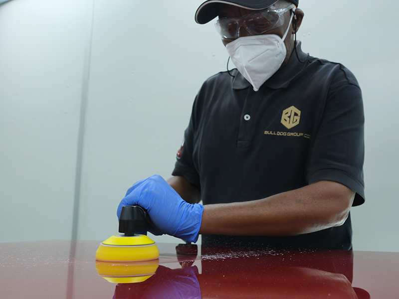 Technician using Hsutech angle polisher head on multi tool body in workshop