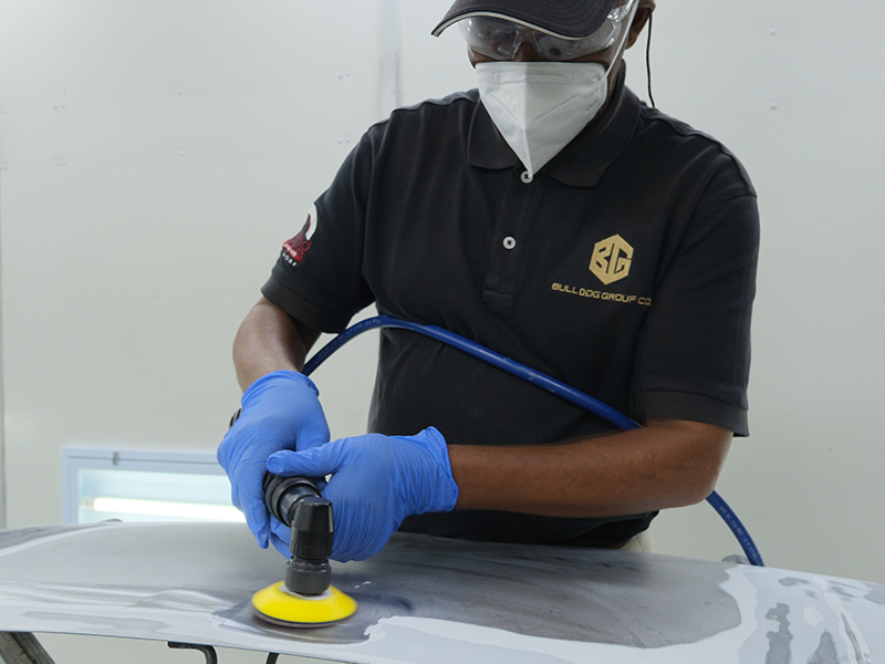 Technician using Hsutech angle orbital sander head on multi tool body in workshop