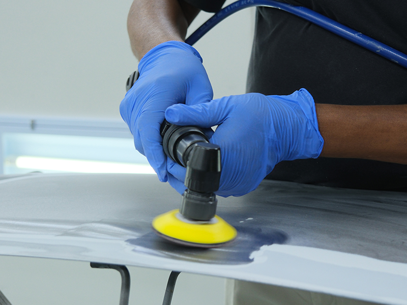 Close up of Hsutech angle orbital sander head in use sanding surface